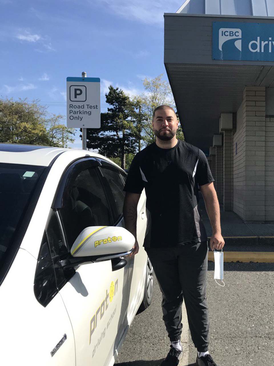 student standing next to car